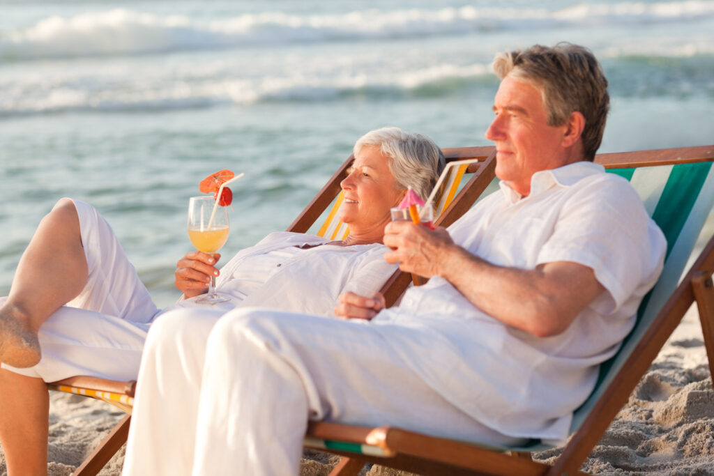 Retired couple relaxing on the beach.